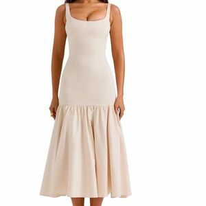 Tulle lining accentuates the pleated, flared skirt of a sleeveless midi dress.